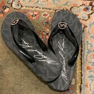 Black Michael Kors signature flip flops. Black and silver, size 6.5